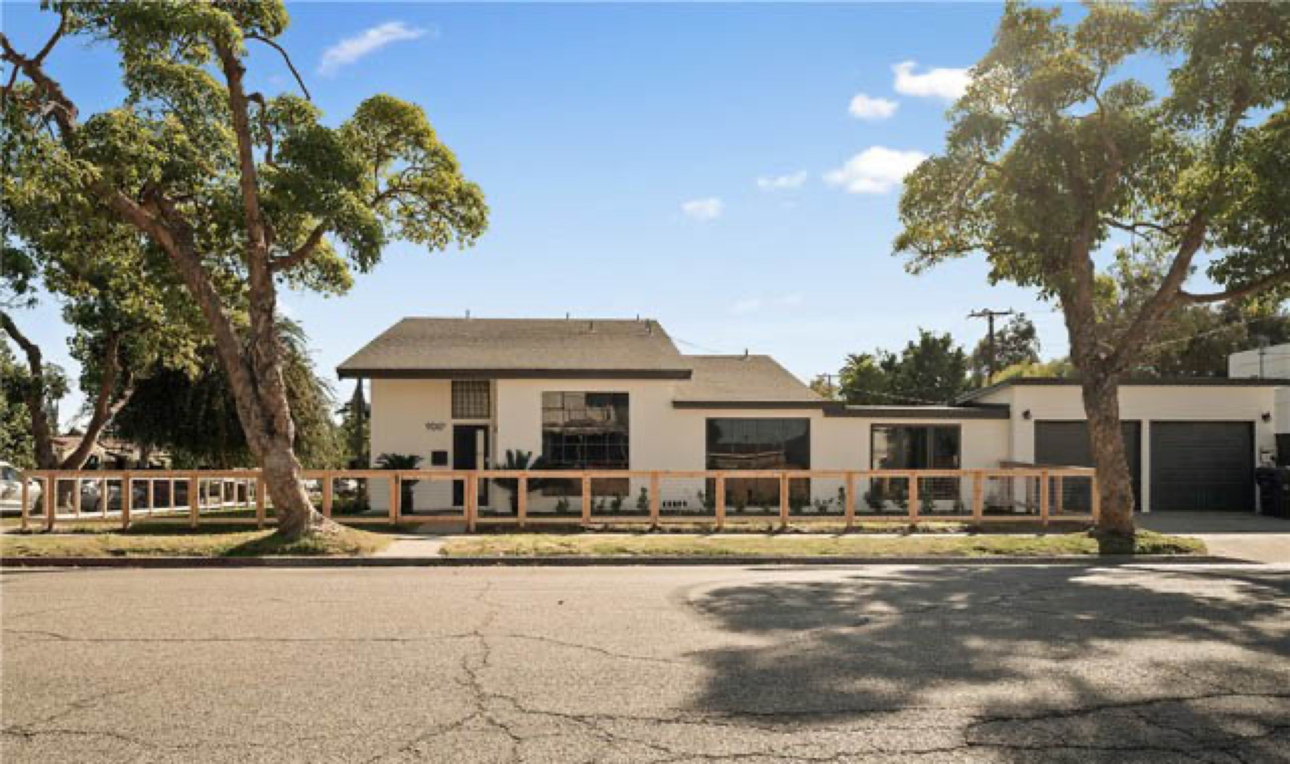 Remodeled home at 900 West Hill Street, Long Beach, behind a wood fence