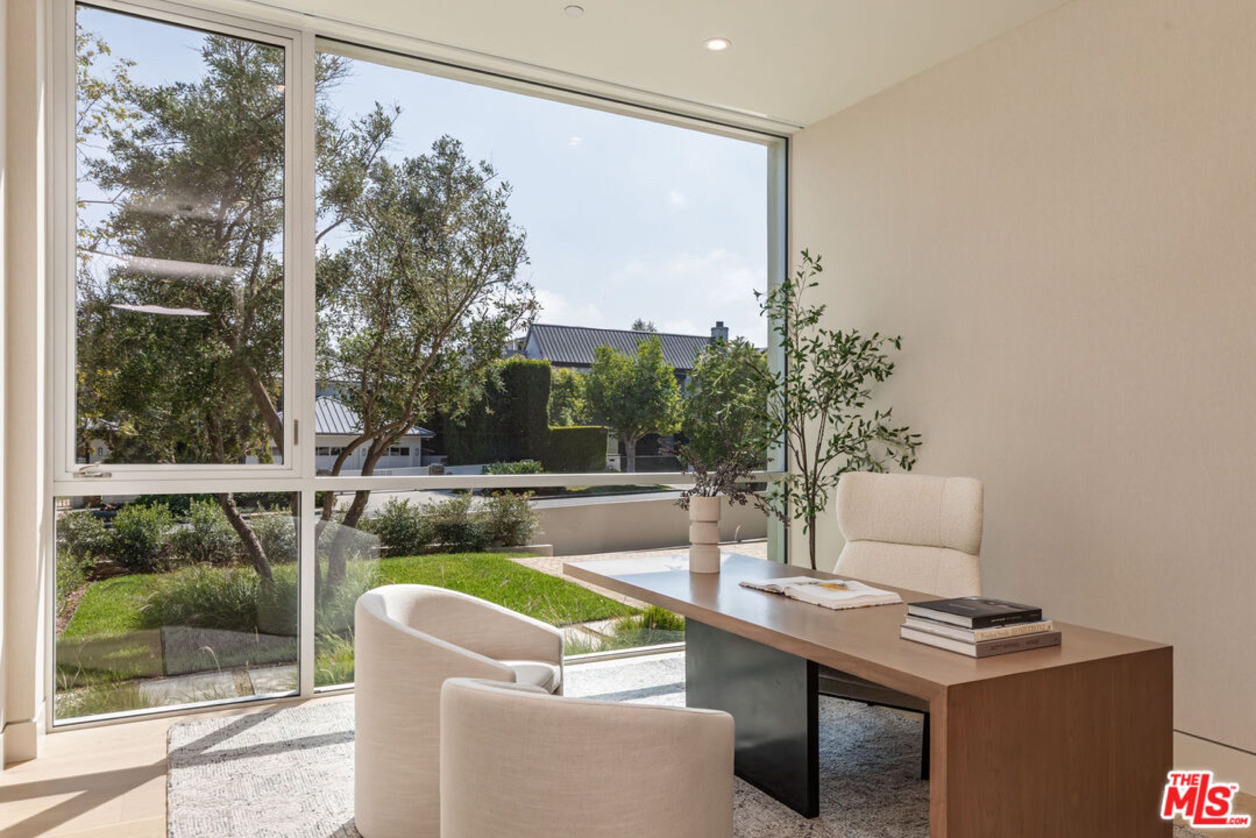 Home office with garden view through corner glazing