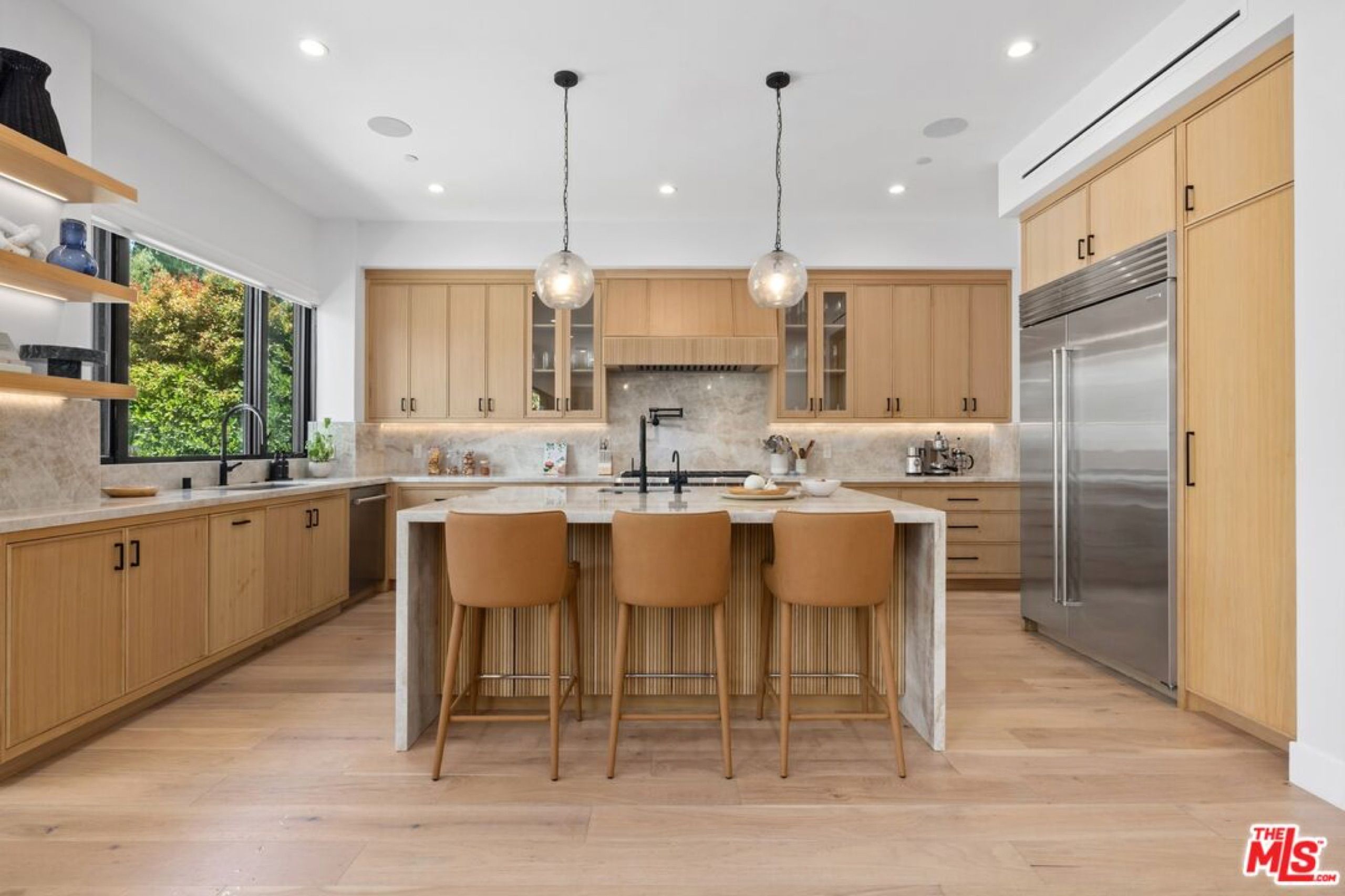 Oak kitchen with waterfall island and pendant lights