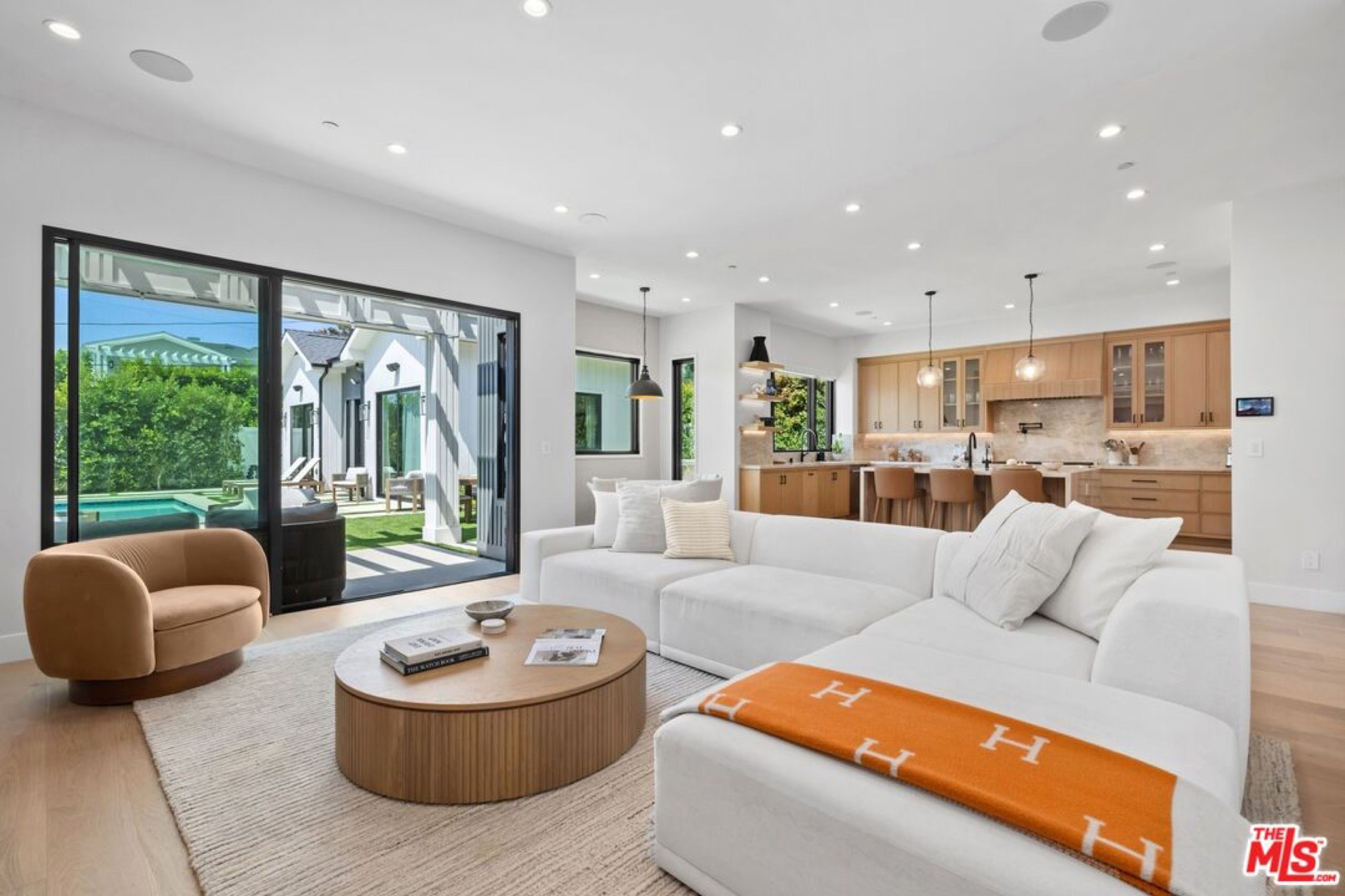 Family room opening to the pool through glass doors