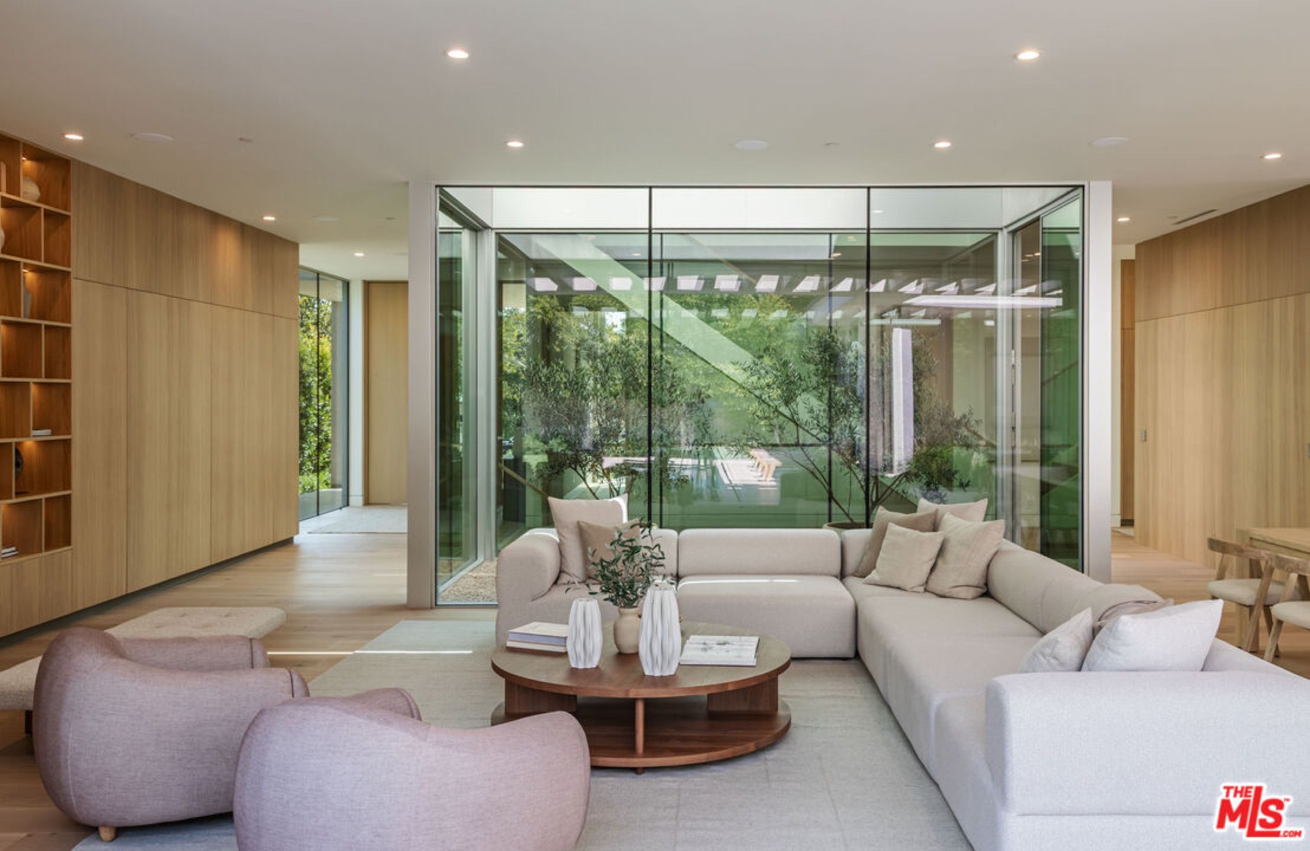 Living area beside a glass walled interior courtyard