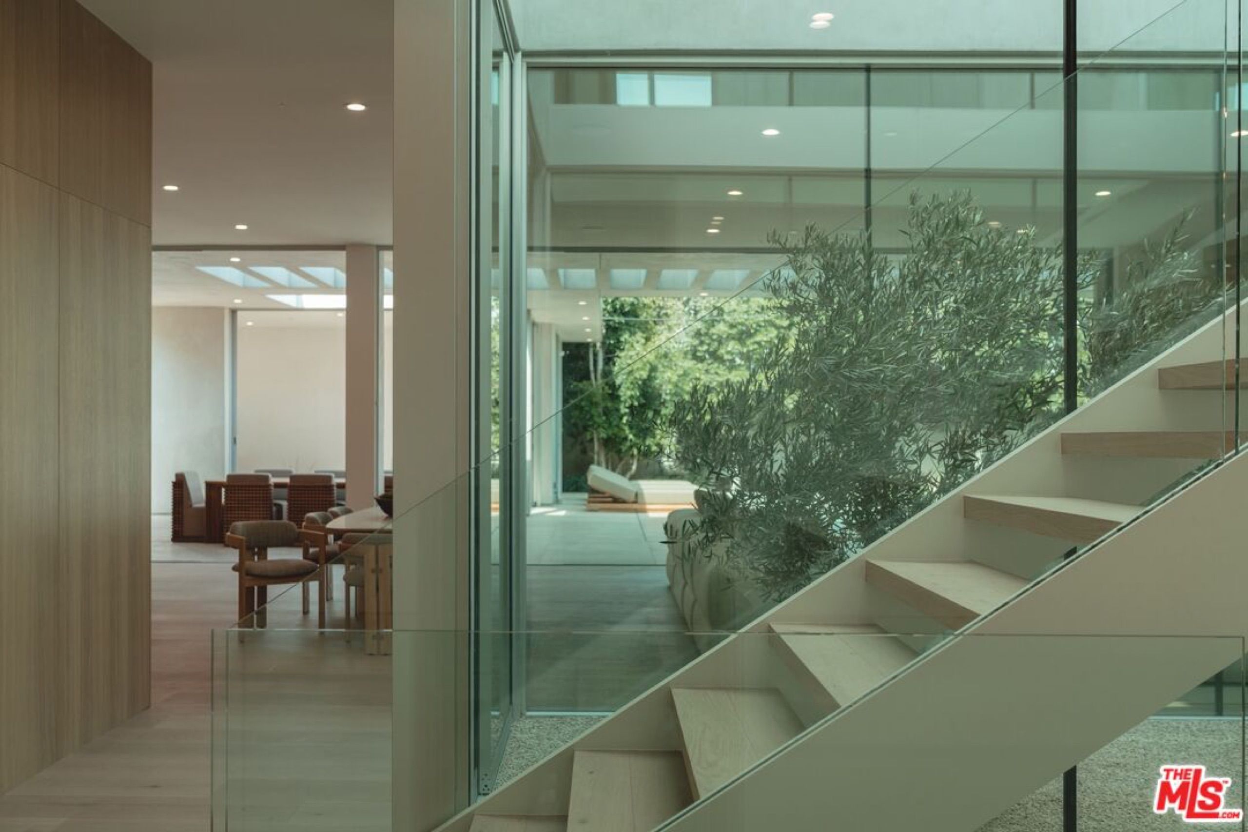 Floating stair inside a glass enclosure