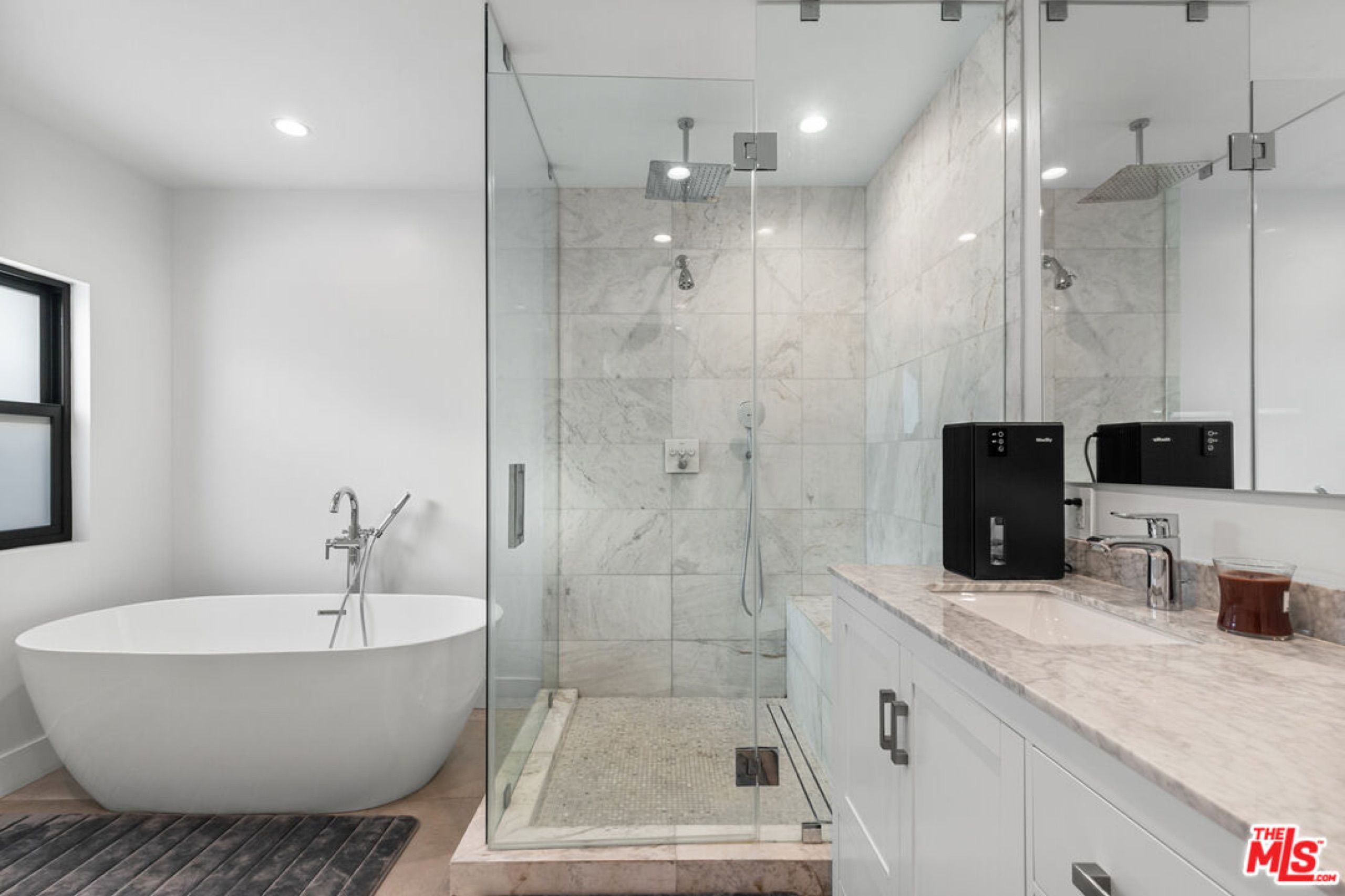 Primary bath with soaking tub and glass steam shower