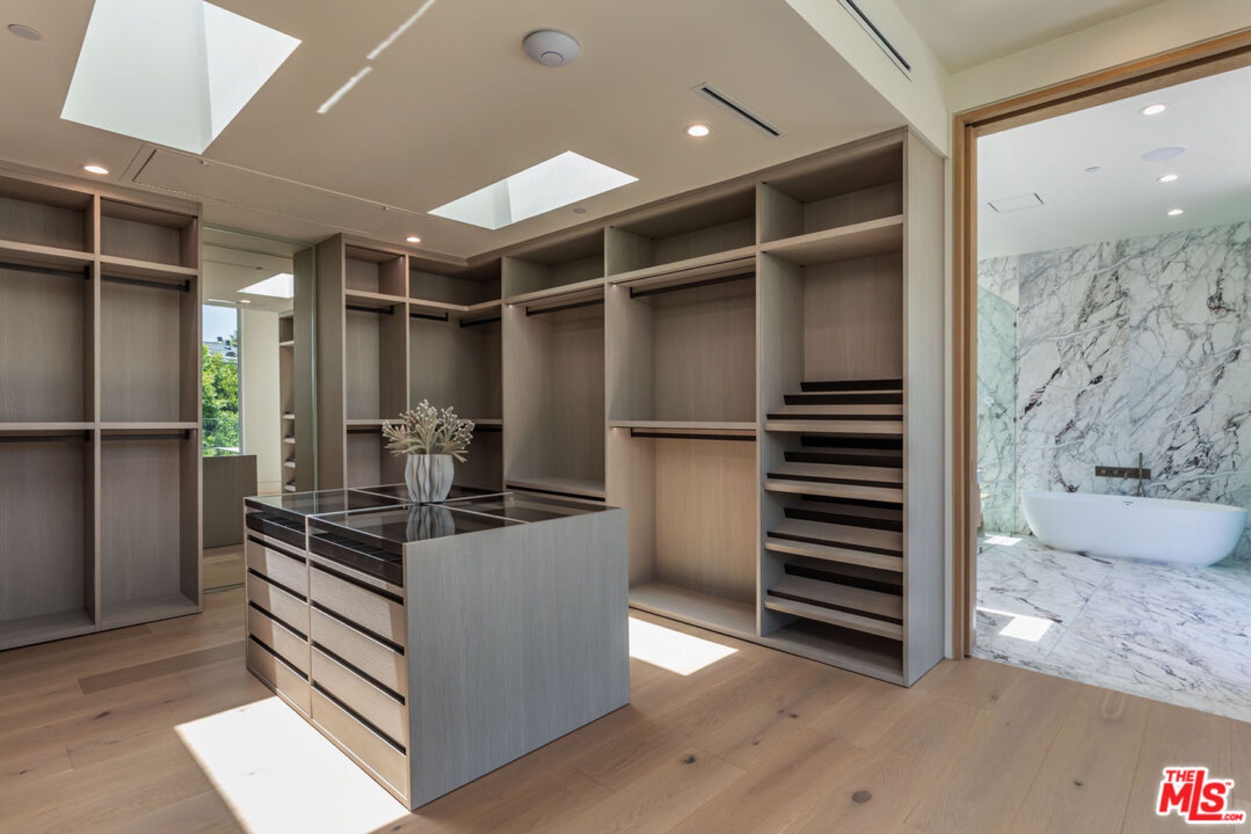 Primary dressing room with island and skylights
